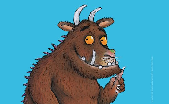 The Gruffalo - a horned, tusked, yellow-eyed beast with a brown hairy body, spines down its back and claws.