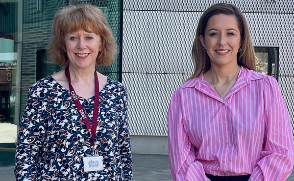 Director Deborah Rees and Sally Jameson MP stand smiling in front of the Cast Building