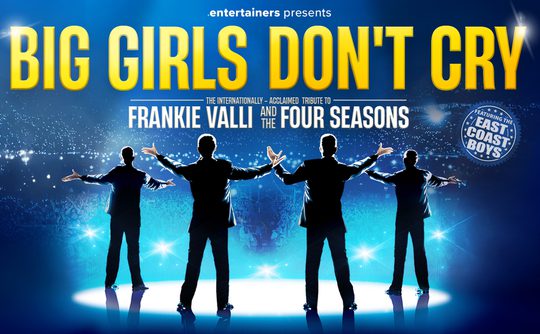Four silhouetted performers with outstretched arms face a cheering crowd on a lit stage. The text reads "Big Girls Don't Cry" in bold yellow.