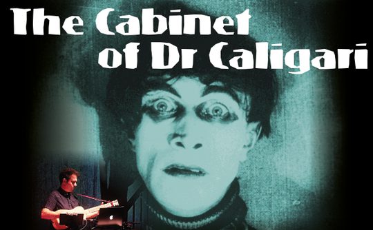 The image features a dramatic black-and-white close-up of a wide-eyed face from "The Cabinet of Dr. Caligari," with a musician playing guitar below.