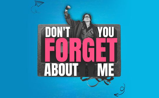 A person in a long coat raises a fist triumphantly. Text reads "Don't You Forget About Me" in bold letters, set against a vibrant blue background.