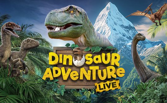 Gigantic dinosaurs, including a T-Rex and Velociraptors, surround a wooden sign reading "Dinosaur Adventure Live" with a snowy mountain backdrop.