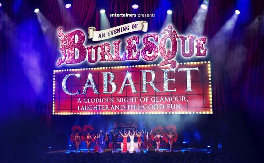 A vibrant stage with performers in feathered costumes beneath "An Evening of Burlesque Cabaret" sign. Bright lights and rich red curtains set a glamorous tone.