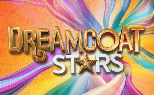 The image features the bold, golden text "DREAMCOAT STARS" on a vibrant swirling rainbow background. A star symbol replaces the "A" in "STARS."