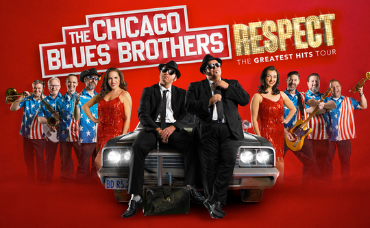Two men in suits and sunglasses sit on a classic car, surrounded by a lively band in American flag shirts. Bold text reads "Respect: The Greatest Hits Tour."