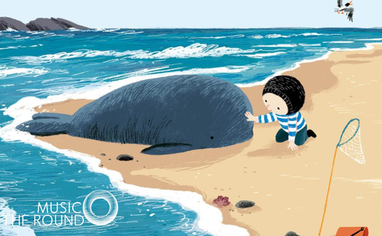 A child with a striped shirt gently touches a beached whale on a sandy shore. The ocean waves lap nearby, and a seagull flies overhead, creating a serene and caring scene.